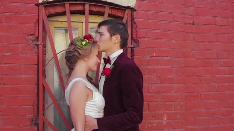 Newlyweds Standing in Front of Red Brick Wall Stock Footage 72331653