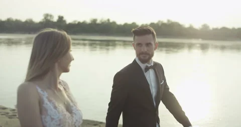 Newlyweds walking on the beach. Stock Footage 99582993