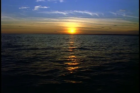 Newport, RI; Dramatic orange sunset with blue sky and dark water Stock Footage 86751619