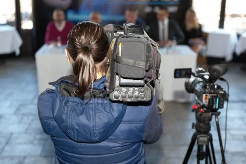 News conference. Filming an event with a video camera. Cameraman. Stock Photos