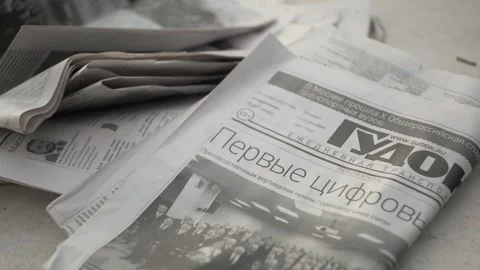 The news paper is on an old wooden table. Close up Stock Footage