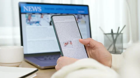 News on the phone and computer screen. Viewing information on the gadget. Press  Stock Footage 308290589