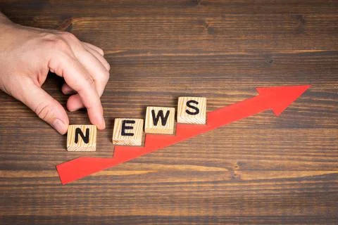 NEWS. Red arrow indicates the development and growth. Steps, wooden background Stock Photos