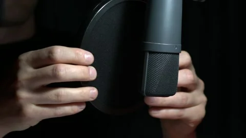 Newscaster/Announcer Adjusts a Studio Microphone Stock Footage 135587519
