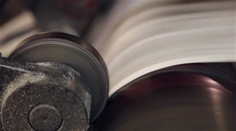 Newspaper being printed in a printing press, close up Stockbeeldmateriaal 57323205