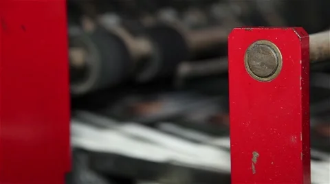 Newspaper being stacked in a printing press, focus defocus Stock Footage 57325184