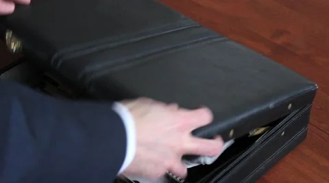 Newspaper into Briefcase Stock Footage 44859731