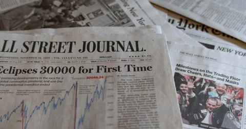 Newspaper coverage of The Dow Jones surpassing 30,000 on the NYSE Stock Footage 144032259