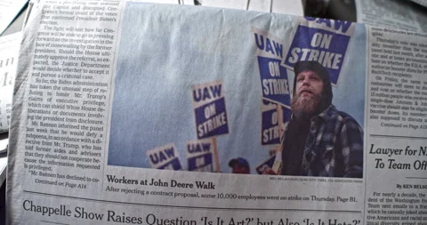 Newspaper Coverage of John Deere Workers Strike in Contract Dispute Stock Footage 168161191