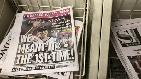Newspaper Coverage of Tom Brady Retiring Again Stock Footage 232404359