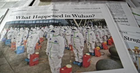 Newspaper Coverage of What happened In Wuhan China to start Pandemic. Stock Footage 168165015