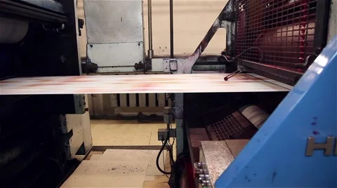 Newspaper in a print line being printed on a printing press, slider shot 스톡 동영상 57322724