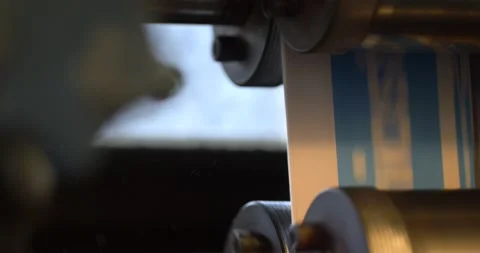 A newspaper roller machine comes to a standstill and dust is visible in Stock Footage 155786119