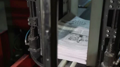 Newspapers fall into large pile and move along the conveyor line. Printing house Stock Footage 171400538