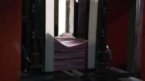 Newspapers fall into large pile and move along the conveyor line. Printing house Stock Footage 171444558