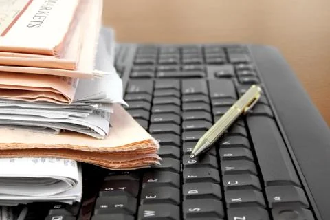 Newspapers on the Keyboard Stock Photos