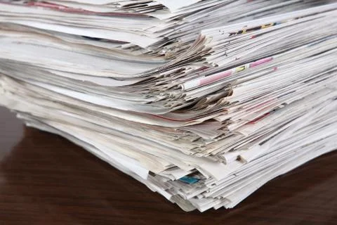 Newspapers pile on the table Stock Photos