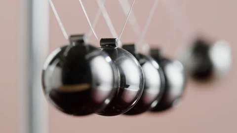 Newton balls close-up, five metallic pendulums on pink background, cradle Stock Footage 204925339