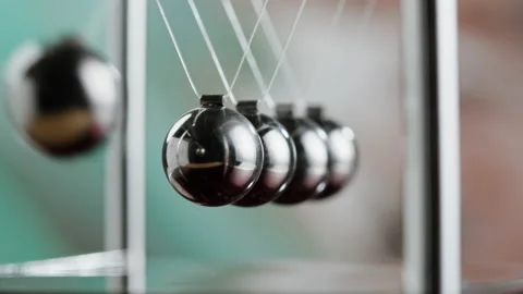 Newton balls close-up, five metallic pendulums colliding, cradle. Physics and Stock Footage 205899457