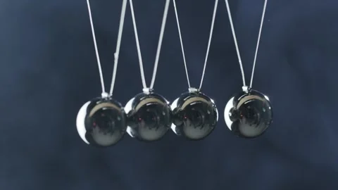 Newtons cradle balance balls movement against dark background with smoke ef.. Stock Footage 335057460