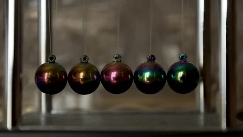 Newton’s Cradle Balls Gently Swaying as Motion Slows Down Stock Footage 344207837