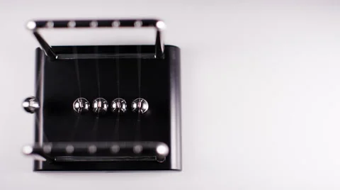 Newton’s cradle chrome balls swinging with copy space Stock Footage