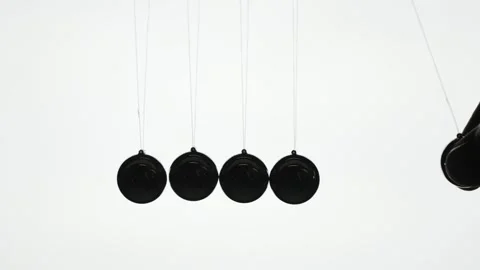 Newtons cradle demonstration showing kinetic energy transfer and momentum p.. Stock Footage 334981380