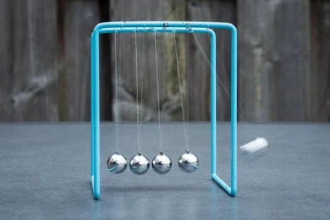 Newtons Cradle Experiment Stock Photos