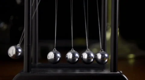 Newton's cradle, side on slow motion shot, 1 ball moving Stock Footage 55392748