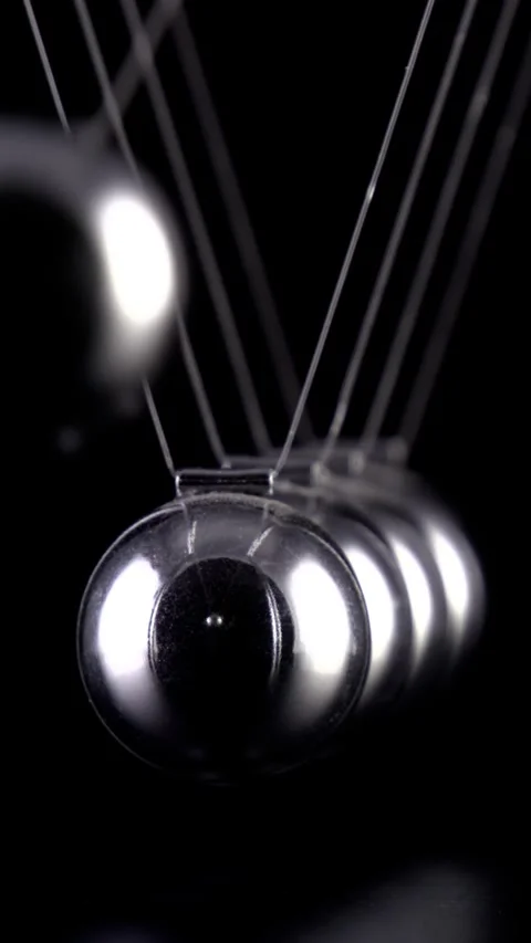 Newton's Cradle Slow Motion. Vertical video. Stock Footage 336974632