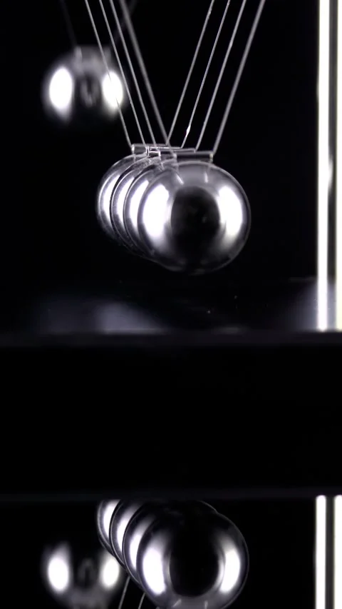 Newton's Cradle Slow Motion. Vertical video. Stock Footage 337435478