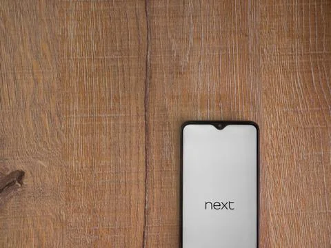 Next app launch screen with logo on the display of a black mobile smartphone  Stock Photos