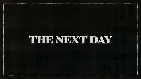 THE NEXT DAY White Font On Black Paper Stock Footage 229997241