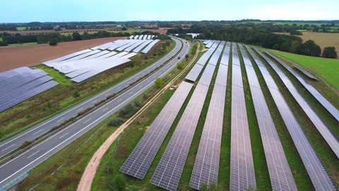 Next to the freeway A20 in Germany is a solar park in slow motion Stock Footage 251524211