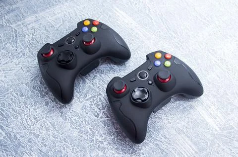 Next-generation game controllers. Two black gamepads. Black joystick. Stock Photos