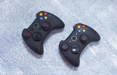 Next-generation game controllers. Two black gamepads. Black joystick. Stock Photos