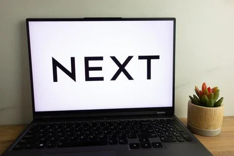 Next plc (styled as NEXT) logo on laptop Stock Photos