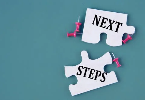 NEXT STEPS concept on mosaic puzzles on a dark green background Stock Photos