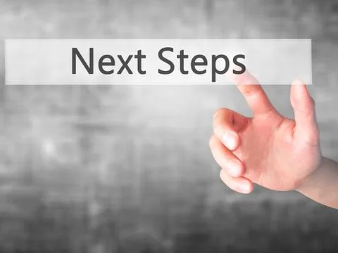 Next Steps - Hand pressing a button on blurred background concept on visual s Stock Photos
