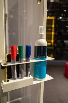 Next to three board markers is a bottle with whiteboard cleaner Stock Photos
