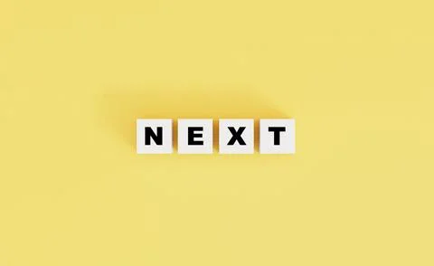 Next wording on white cube block on yellow background by 3d rendering . Stock Photos