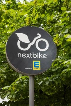 Nextbike Logo In Front of Trees In Berlin, Germany Stock Photos