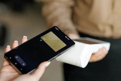 NFC mobile payment with smartphone at wireless POS terminal Stock Photos