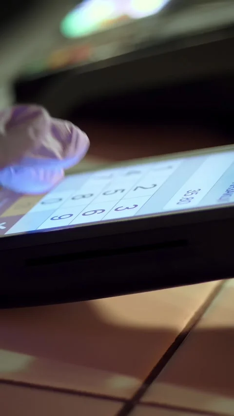 NFC technology. close-up. waiter, in protective gloves, prints amount into Stock-Footage 320773630