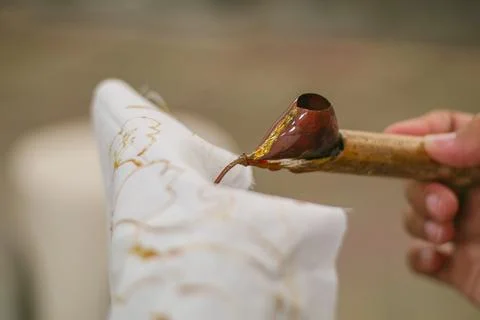 Ngeresi batik is The process of making batik still uses the traditional can.. Stock Photos