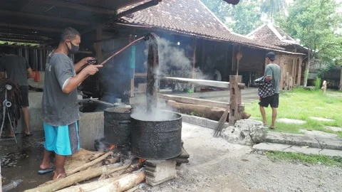 Nglorod batik process to dissolves the wax from the batik fabric Stock Footage 143812726