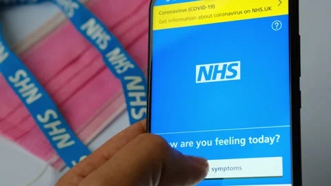 NHS app. App that help to identify COVID-19 symptoms. Face mask, NHS lanyard and Stock Footage 141158043