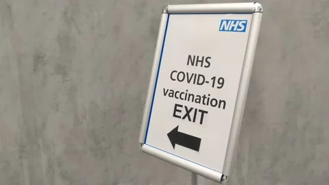 NHS COVID VACCINATION CENTRE EXIT SIGN UK 4K Stock Footage 154553313