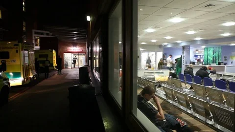 NHS A&amp;E exterior night as man waits in reception Stock Footage 97502053