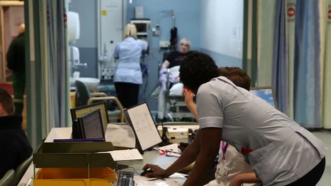 NHS A&E staff nurse at computer Stock Footage
